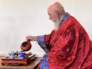 man sitting pouring tea
