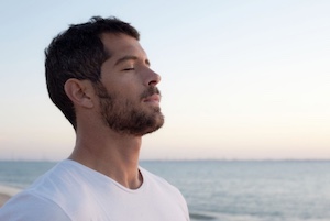 portrait of man with eyes closed meditating