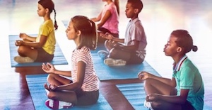 kids sitting in lotus pose meditating