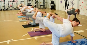 women in gym doing yoga